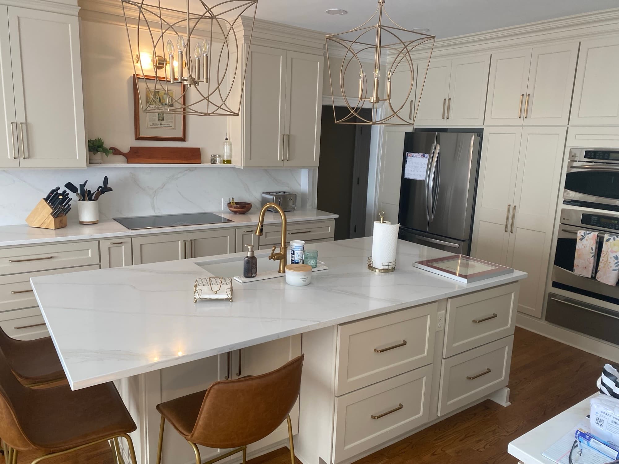 Cream kitchen with marble counters and brass hardware