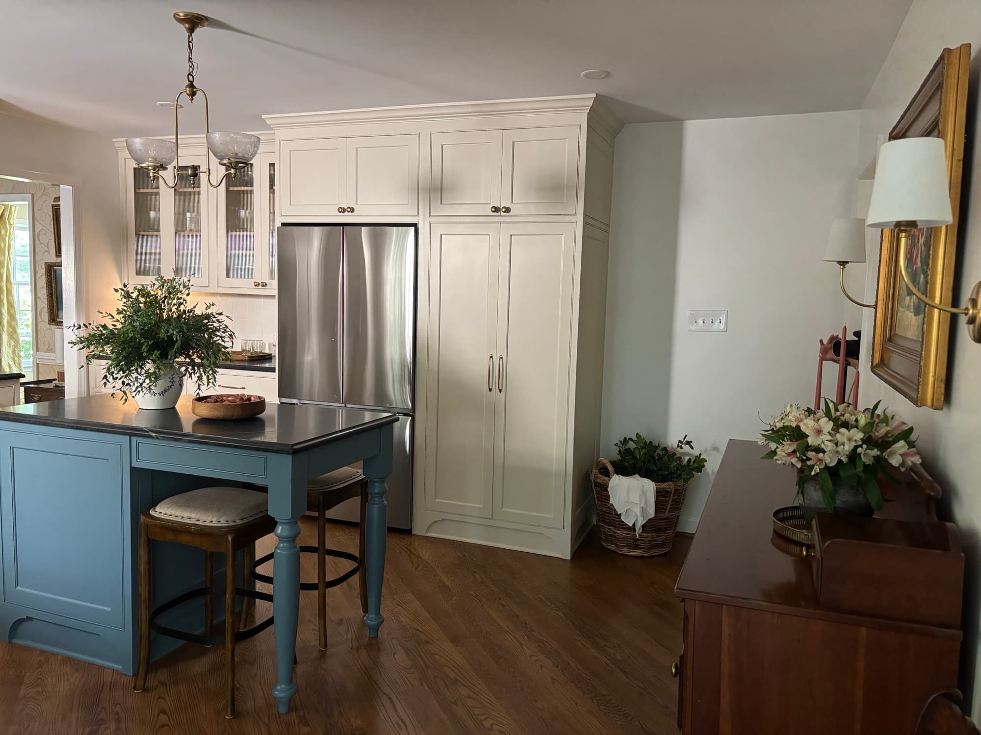 Custom pantry cabinets beside a refrigerator wall